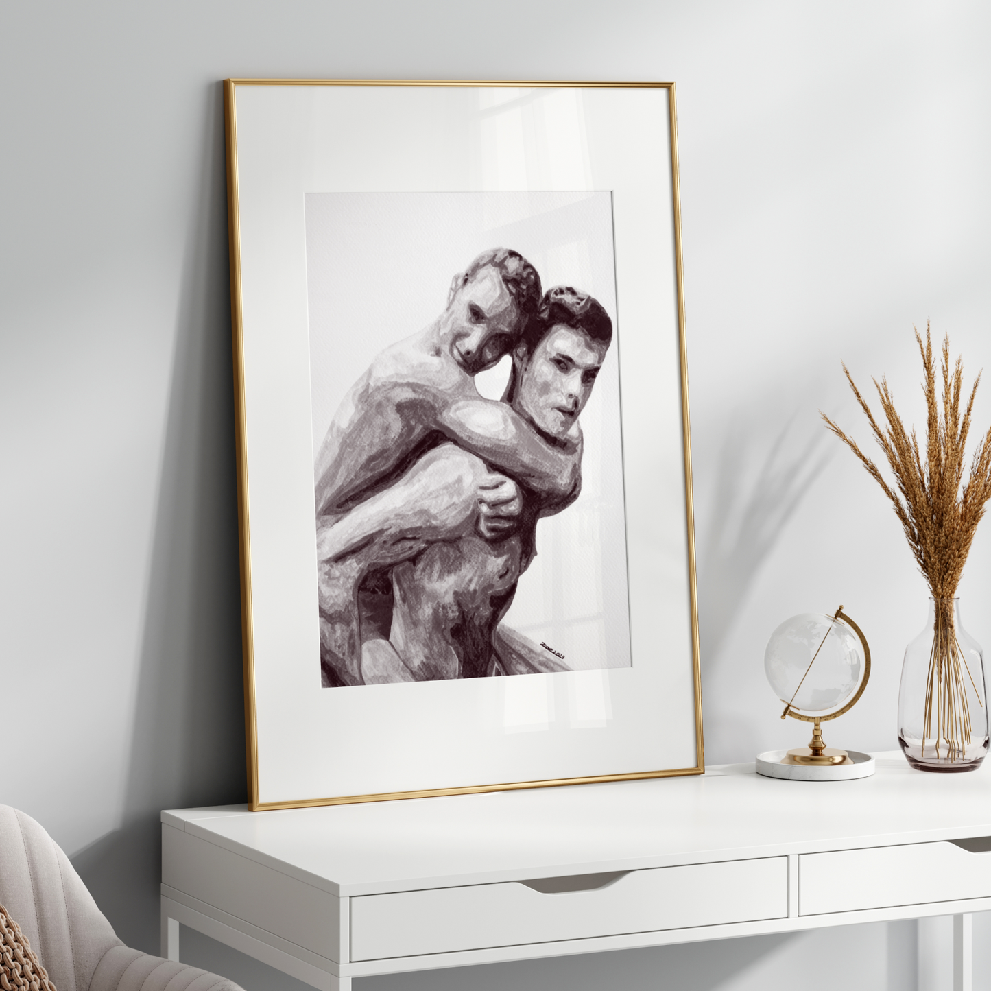 Framed artwork of a man hugging a sculpture on a white console table with decorative items.