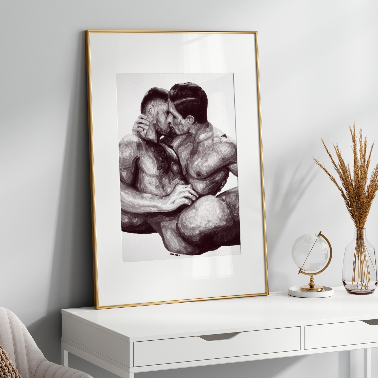 Framed black and white artwork of two people embracing on a white shelf with decorative items.