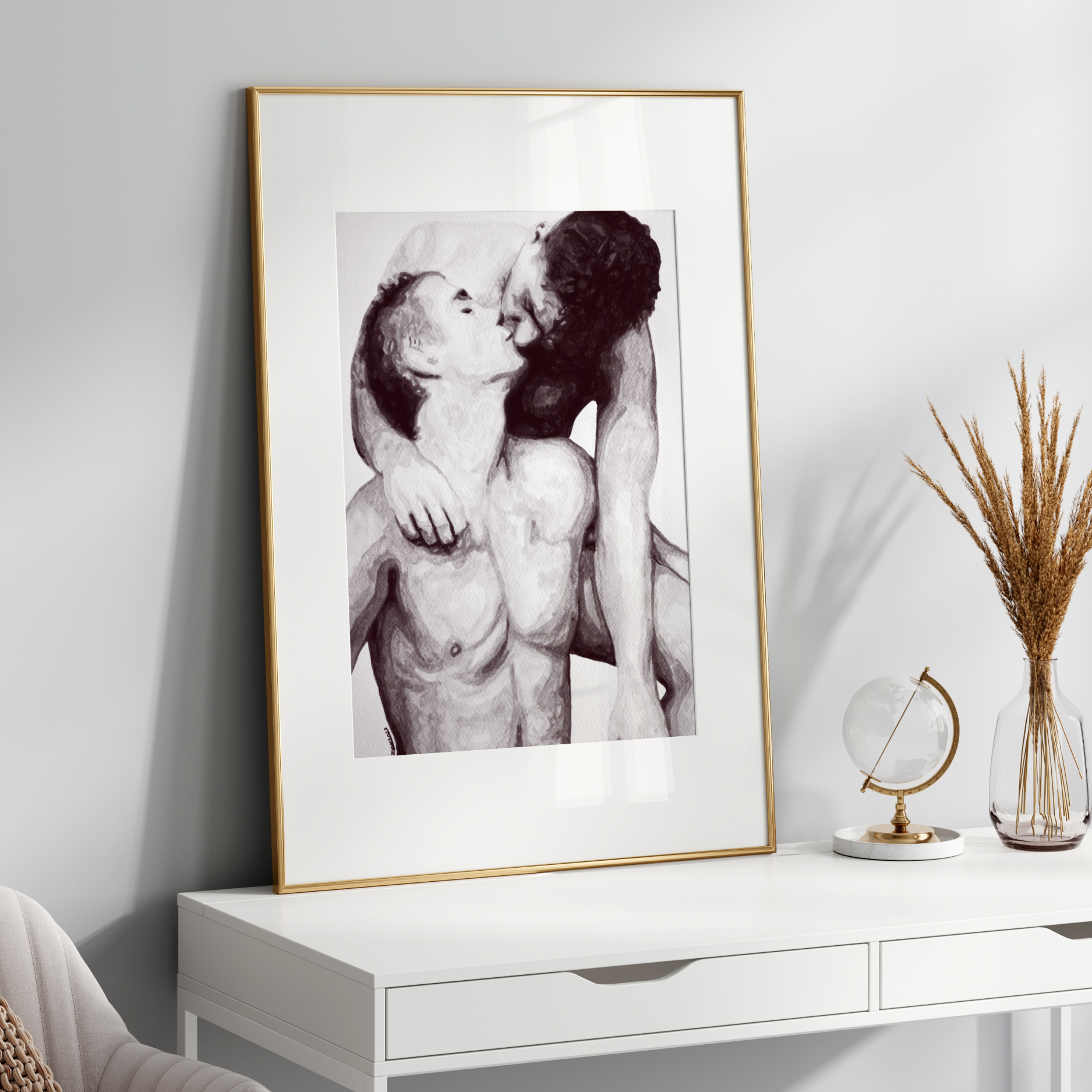 Framed black and white artwork of two people embracing on a white shelf with decorative items.