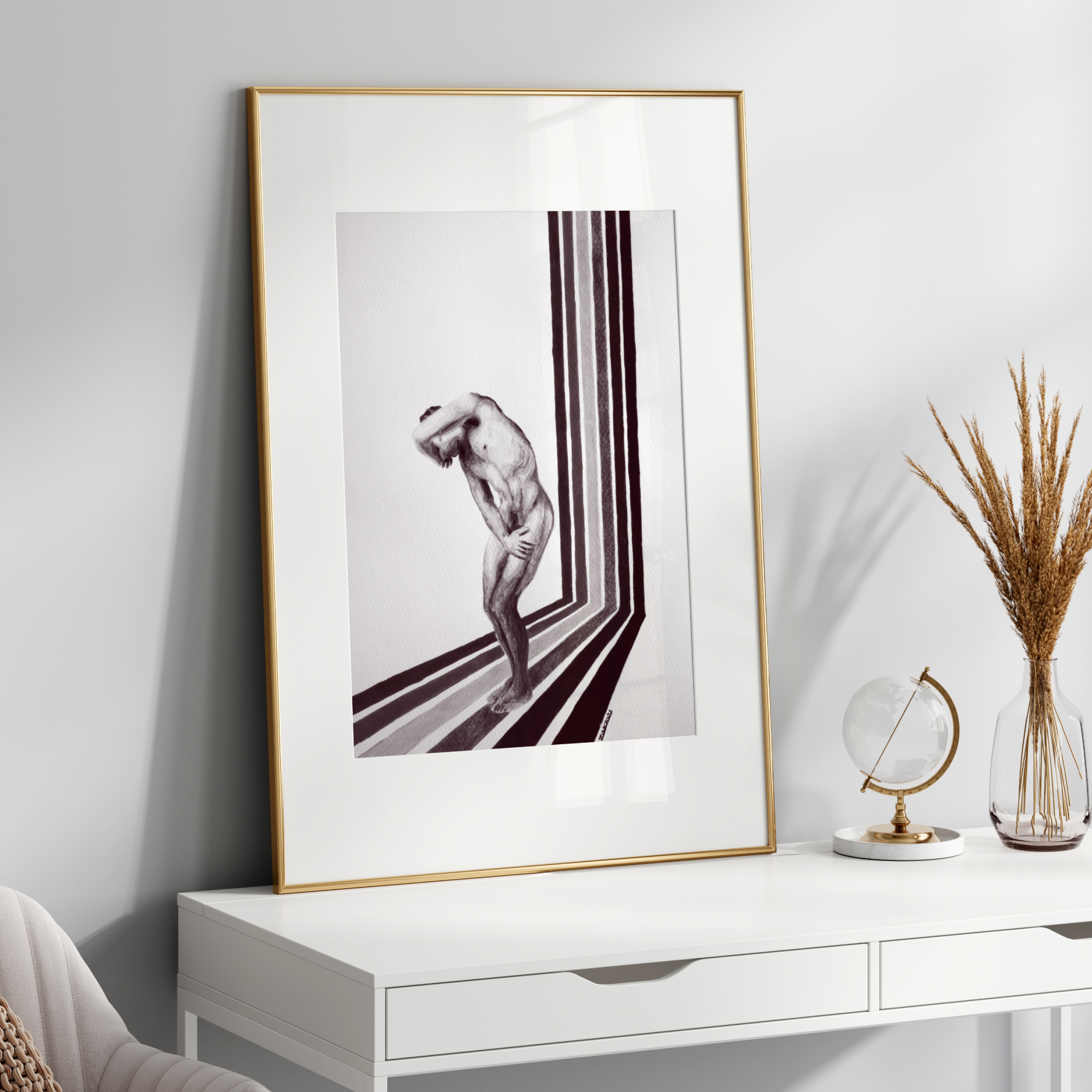 Framed black and white artwork on a white wall above a white console table with decorative items.