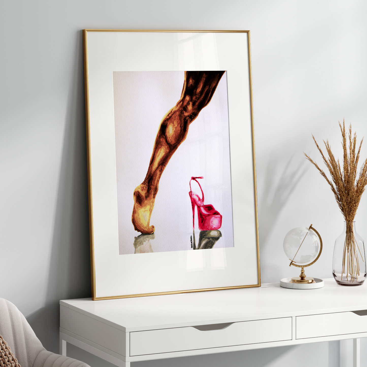 Framed artwork on a white wall above a white console table with decorative items.