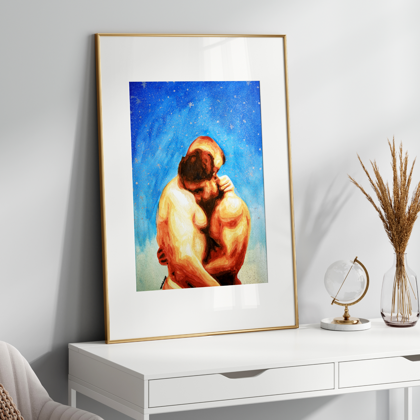 Framed artwork of two people embracing on a white surface with decorative items.