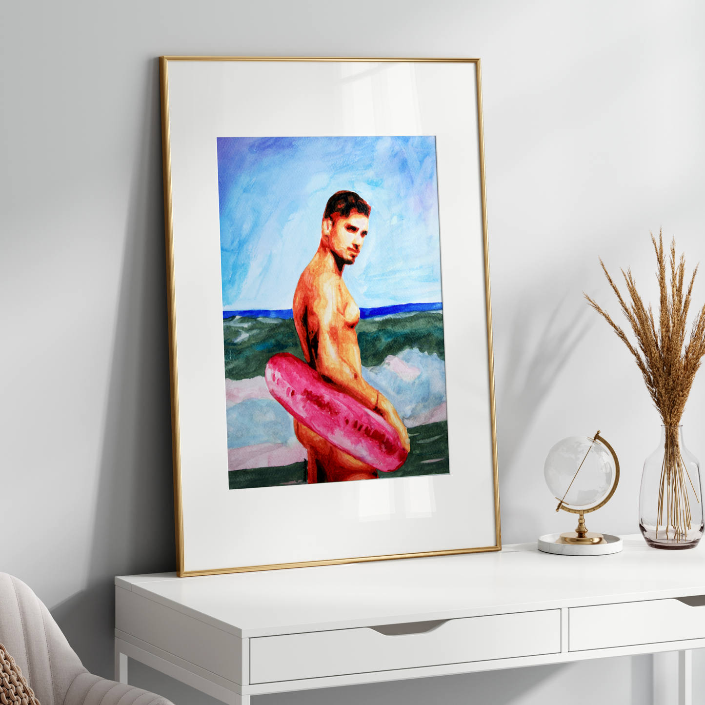 Framed artwork of a man with a pink surfboard on a white wall above a white console table.