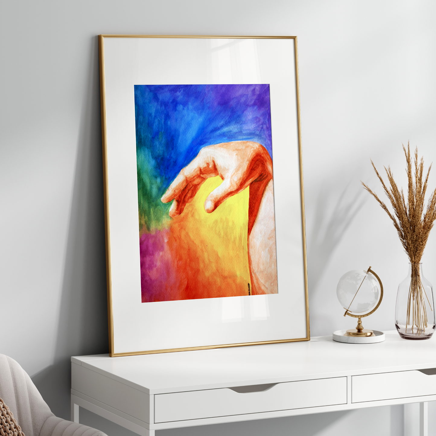 Framed colorful artwork on a white wall above a white console table.
