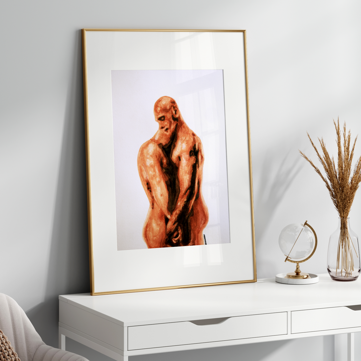 Framed artwork of a nude figure on a white console table with decorative items.