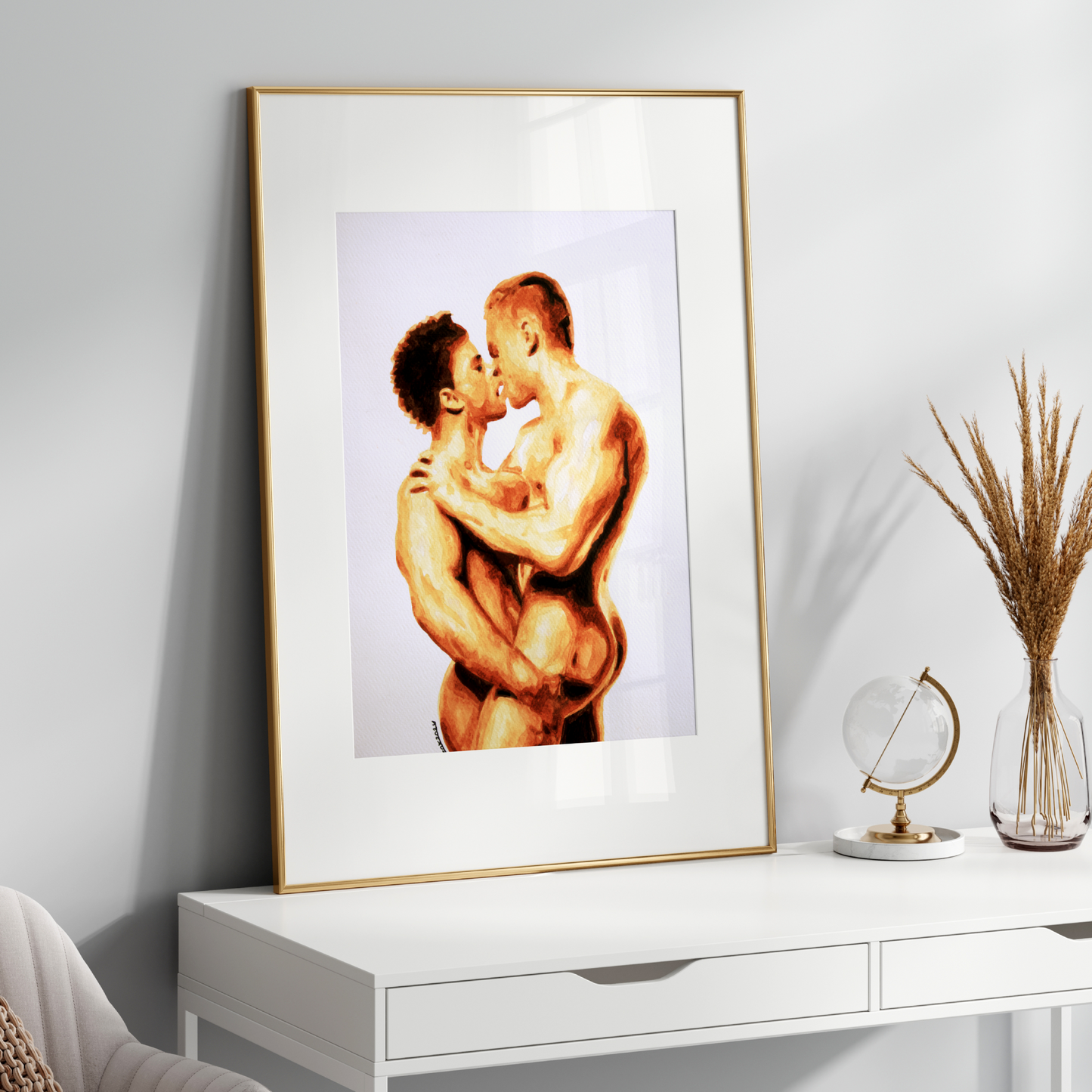 Framed artwork of two nude figures embracing on a white wall above a white console table.