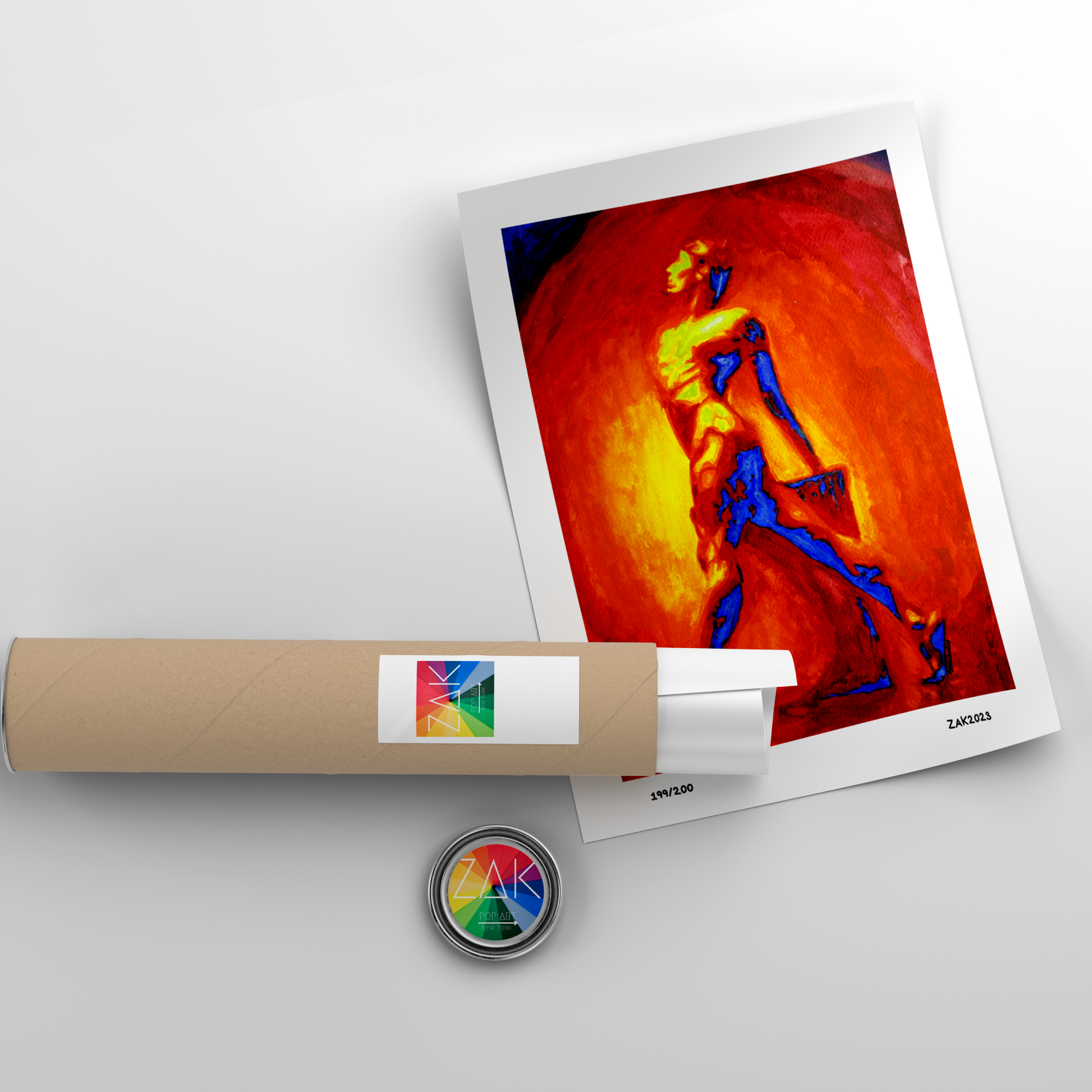 Artistic print of a colorful abstract design on a white background with a roll of paper and a small round object.