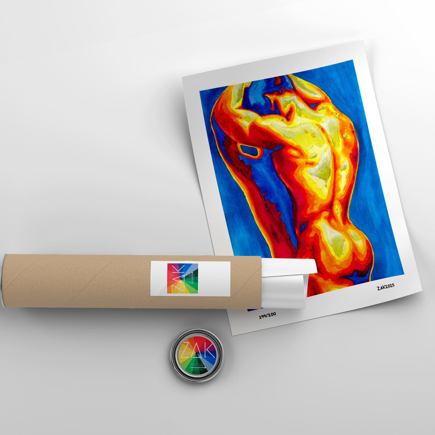 Colorful thermal imaging print with a roll of paper and a small round object on a light gray background