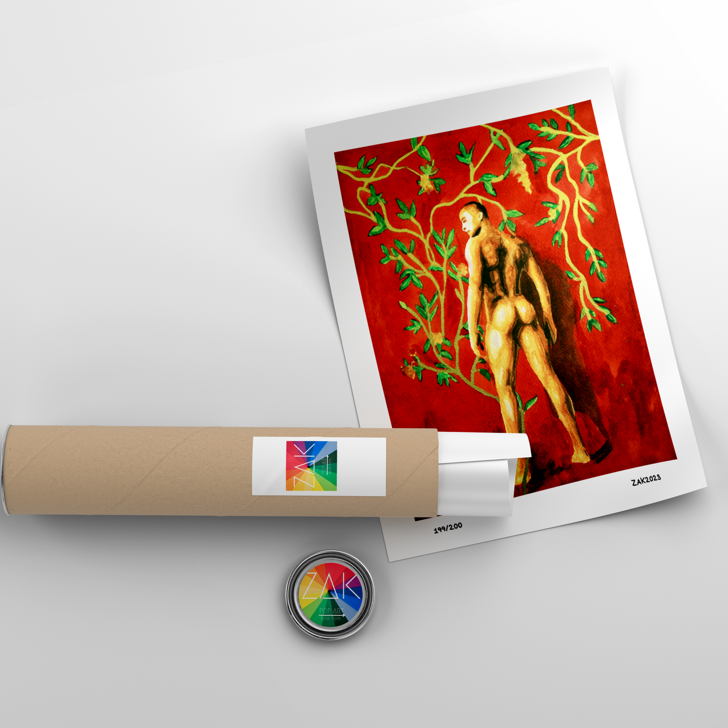 Artistic print of a nude figure with green leaves on a red background, accompanied by a roll of paper and a small round object.