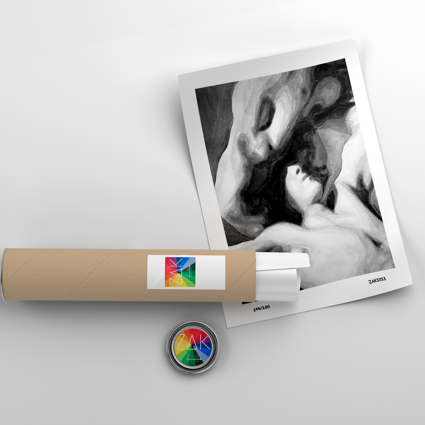 Roll of paper with a colorful label and a photo album on a light gray background