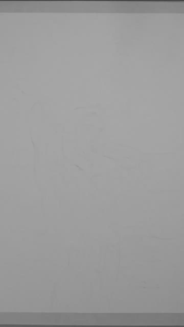 Black and white watercolor painting of a muscular nude man standing by the ocean, flexing his arms behind his head. The silhouette contrasts with a softly textured sky and sea, conveying queer strength, calm, and confidence.