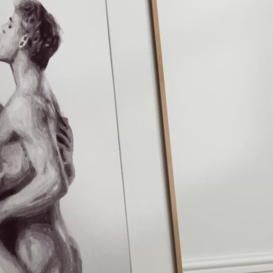 video artwork of two nude figures embracing on a white background
