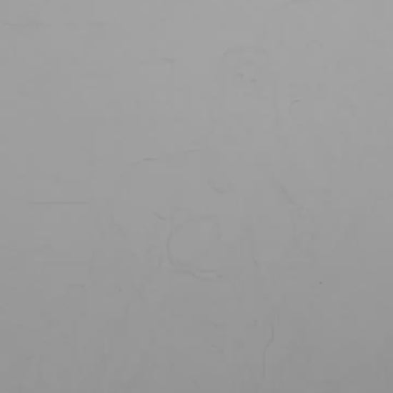 A black and white art video featuring a nude male figure with a muscular build, seated next to a wave or a column in a dramatic pose.
