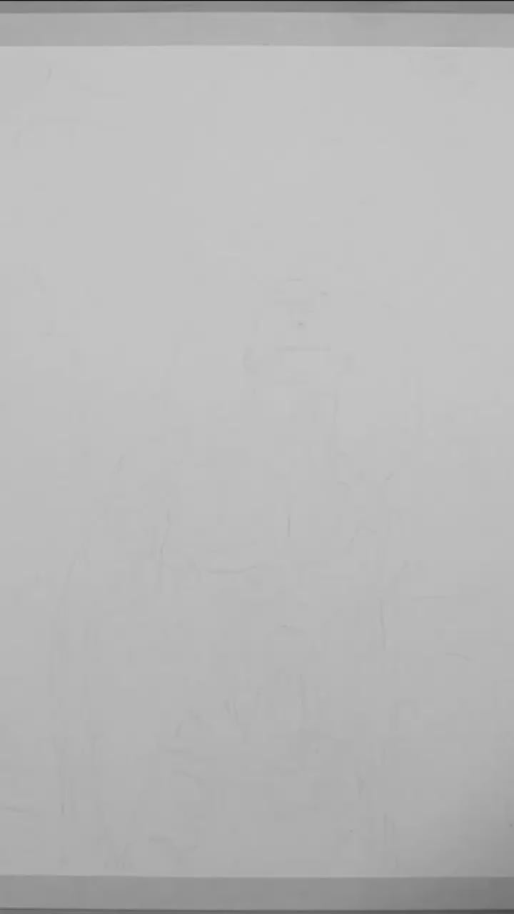 A black and white art video featuring a shirtless male figure with a background of stars and a night sky.
